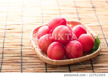 Early plums arranged in a basket 127521933