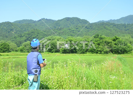 Spraying pesticides with agricultural drones 127523275