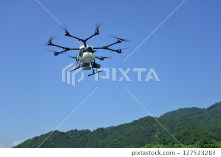 Spraying pesticides with agricultural drones Spraying pesticides with agricultural drones 127523283