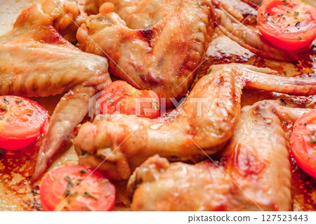 fried chicken wings with tomatoes, selective focus fried chicken wings with tomatoes, selective focus 127523443