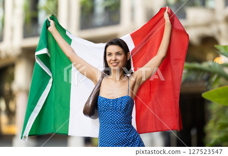 Young woman with Italian flag on city street Young woman with Italian flag on city street 127523547
