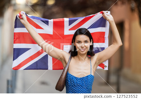 Young woman with UK flag on city street 127523552