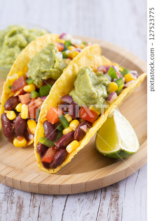 Vegan mexican Taco with beans and guacamole Vegan mexican Taco with beans and guacamole 127523775