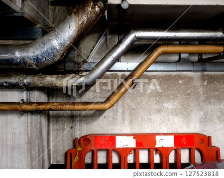 Industrial Metal Pipes on the Walls in a Car Park Building Industrial Metal Pipes on the Walls in a Car Park Building 127523818