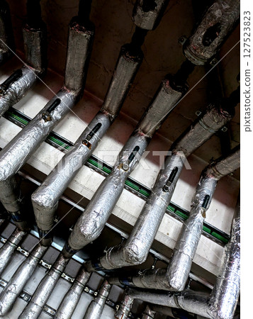 Industrial Metal Pipes on the Walls in a Car Park Building 127523823