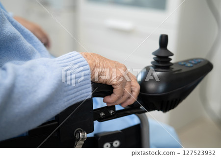 Asian senior woman patient on electric wheelchair with remote control at hospital, healthy strong medical concept. Asian senior woman patient on electric wheelchair with remote control at hospital, healthy strong medical concept. 127523932