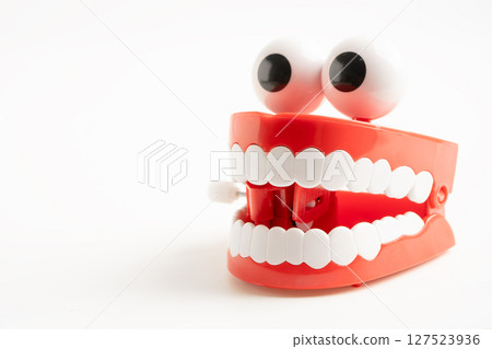 Tooth funny toy denture red color jaw and eye on white background with copy space. Tooth funny toy denture red color jaw and eye on white background with copy space. 127523936