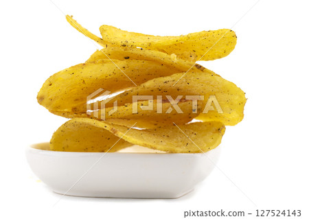 Chips on a white plate are photographed close-up. Chips on a white plate are photographed close-up. 127524143