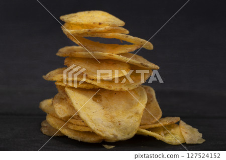Chips stacked in a slide on a gray background close-up. Chips stacked in a slide on a gray background close-up. 127524152
