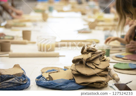 Clay master class. A large piece of clay for making pottery. Potter's work table. 127524233