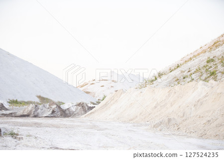 Beautiful landscape of white mountains and sand. Unusual natural landscape. Waste from old chemical production. 127524235
