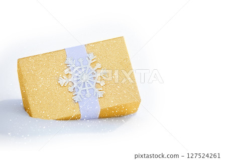 Gift gold box on a snowy background. 127524261
