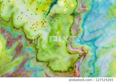 Multicolored colorful background of yellow and green paints in the form of a wave covered with gold sparkles. 127524265