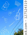 Various musical instruments drawn in the blue sky 127524319