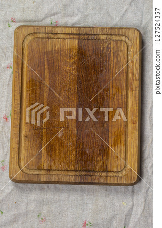 Cutting wood board on a gray background vertically. 127524357