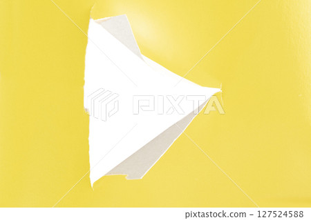 Yellow paper with a cut triangle in the middle. 127524588