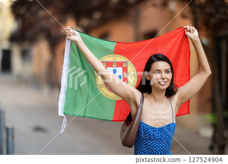 Young woman with portuguese flag on city street Young woman with portuguese flag on city street 127524904