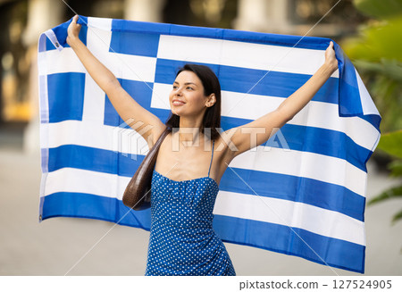 Young woman with Greek flag on city street Young woman with Greek flag on city street 127524905