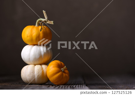 Baby Boo pumpkins arranged on wooden surface Baby Boo pumpkins arranged on wooden surface 127525126
