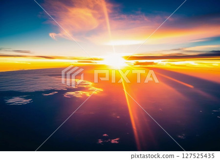 Bright rays of sunlight illuminate the vast ocean as dawn breaks, casting a warm glow over the tranquil waters, creating a serene and magical atmosphere Generative AI 127525435