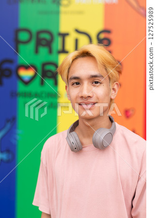 Handsome gay man portrait against pride rainbow background 127525989