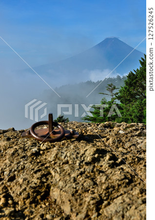 A view of cloud-covered summer Mt. Fuji from a rocky observation deck in the Misaka Mountains A view of cloud-covered summer Mt. Fuji from a rocky observation deck in the Misaka Mountains 127526245