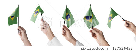 The Brazil flag in hand in different angles on a white background 127526455