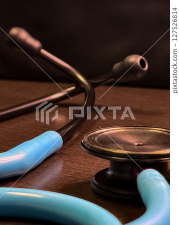 Blue Stethoscope Close-up on Medical Desk 127526814