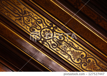 Detailed image showcasing an ornate golden and brown inlay pattern 127527447