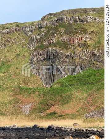 Giant's Causeway is a UNESCO World Heritage Site on Northern Ireland's Antrim Coast, famous for hexagonal stones by volcanic activity and beautiful coast. Giant's Causeway is a UNESCO World Heritage Site on Northern Ireland's Antrim Coast, famous for hexagonal stones by volcanic activity and beautiful coast. 127528234
