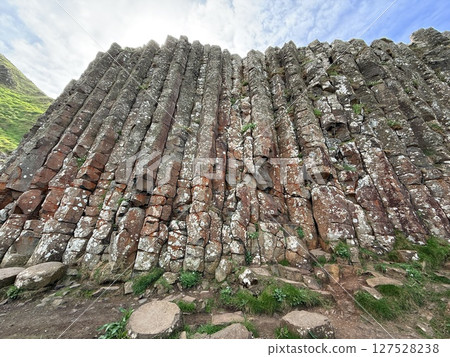 Giant's Causeway is a UNESCO World Heritage Site on Northern Ireland's Antrim Coast, famous for hexagonal stones by volcanic activity and beautiful coast. 127528238