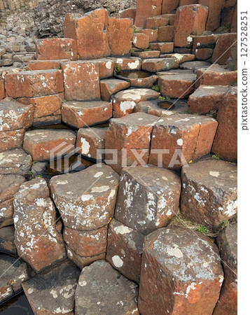 The Giant's Causeway is a UNESCO World Heritage Site on the Antrim coast of Northern Ireland, famous for its hexagonal rock formations formed by volcanic activity and beautiful beaches. The Giant's Causeway is a UNESCO World Heritage Site on the Antrim coast of Northern Ireland, famous for its hexagonal rock formations formed by volcanic activity and beautiful beaches. 127528251