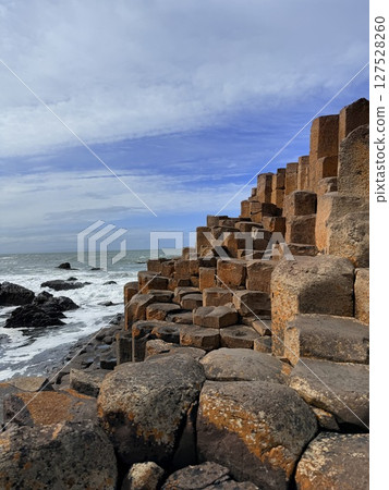 Giant's Causeway is a UNESCO World Heritage Site on Northern Ireland's Antrim Coast, famous for hexagonal stones by volcanic activity and beautiful coast. Giant's Causeway is a UNESCO World Heritage Site on Northern Ireland's Antrim Coast, famous for hexagonal stones by volcanic activity and beautiful coast. 127528260