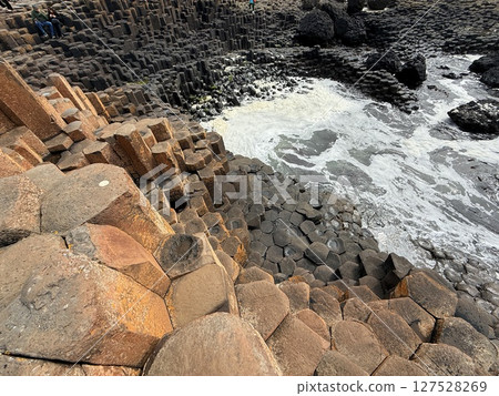 Giant's Causeway is a UNESCO World Heritage Site on Northern Ireland's Antrim Coast, famous for hexagonal stones by volcanic activity and beautiful coast. Giant's Causeway is a UNESCO World Heritage Site on Northern Ireland's Antrim Coast, famous for hexagonal stones by volcanic activity and beautiful coast. 127528269