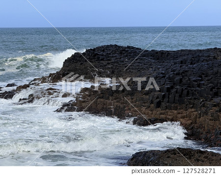 Giant's Causeway is a UNESCO World Heritage Site on Northern Ireland's Antrim Coast, famous for hexagonal stones by volcanic activity and beautiful coast. Giant's Causeway is a UNESCO World Heritage Site on Northern Ireland's Antrim Coast, famous for hexagonal stones by volcanic activity and beautiful coast. 127528271