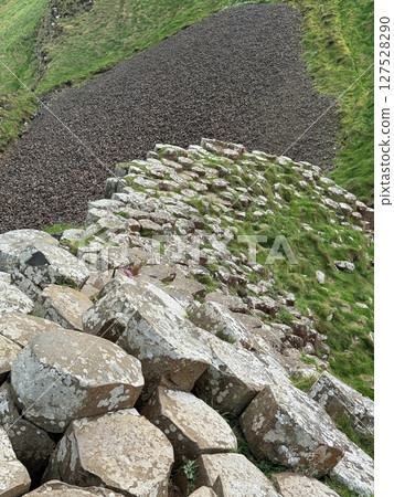 Giant's Causeway is a UNESCO World Heritage Site on Northern Ireland's Antrim Coast, famous for hexagonal stones by volcanic activity and beautiful coast. Giant's Causeway is a UNESCO World Heritage Site on Northern Ireland's Antrim Coast, famous for hexagonal stones by volcanic activity and beautiful coast. 127528290