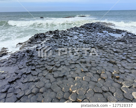 Giant's Causeway is a UNESCO World Heritage Site on Northern Ireland's Antrim Coast, famous for hexagonal stones by volcanic activity and beautiful coast. Giant's Causeway is a UNESCO World Heritage Site on Northern Ireland's Antrim Coast, famous for hexagonal stones by volcanic activity and beautiful coast. 127528337
