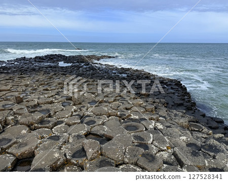 Giant's Causeway is a UNESCO World Heritage Site on Northern Ireland's Antrim Coast, famous for hexagonal stones by volcanic activity and beautiful coast. Giant's Causeway is a UNESCO World Heritage Site on Northern Ireland's Antrim Coast, famous for hexagonal stones by volcanic activity and beautiful coast. 127528341