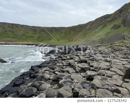 Giant's Causeway is a UNESCO World Heritage Site on Northern Ireland's Antrim Coast, famous for hexagonal stones by volcanic activity and beautiful coast. Giant's Causeway is a UNESCO World Heritage Site on Northern Ireland's Antrim Coast, famous for hexagonal stones by volcanic activity and beautiful coast. 127528342