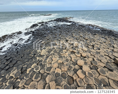 Giant's Causeway is a UNESCO World Heritage Site on Northern Ireland's Antrim Coast, famous for hexagonal stones by volcanic activity and beautiful coast. Giant's Causeway is a UNESCO World Heritage Site on Northern Ireland's Antrim Coast, famous for hexagonal stones by volcanic activity and beautiful coast. 127528345