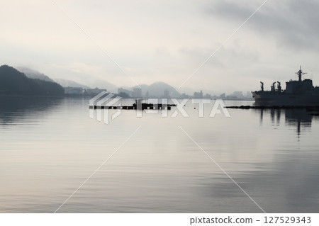 A fishing port shrouded in mist early in the morning 127529343