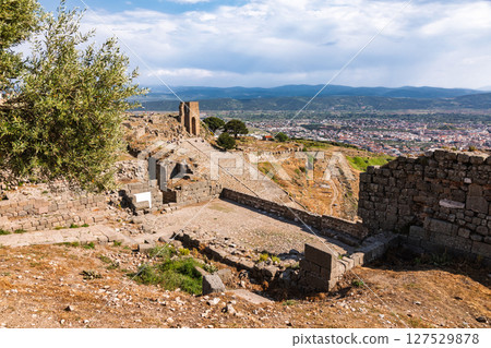 Scenic view of Pergamon theatre and city of Bergama from upper acropolis with ancient ruins and olive tree in foreground Scenic view of Pergamon theatre and city of Bergama from upper acropolis with ancient ruins and olive tree in foreground 127529878