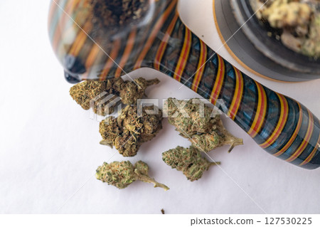 Marijuana Cannabis weed buds with pipe and grinder. Marijuana Cannabis weed buds with pipe and grinder. 127530225