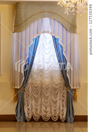 Elegant blue and white draped curtains with valance Elegant blue and white draped curtains with valance 127530349