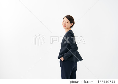 A woman in a suit looking back A woman in a suit looking back 127530753