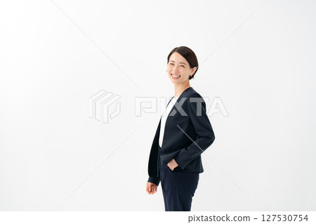 A woman in a suit looking back A woman in a suit looking back 127530754