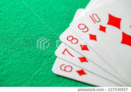 Poker, combination of straight flush cards of the red suit of diamonds from six to ten, selective focus 127530957