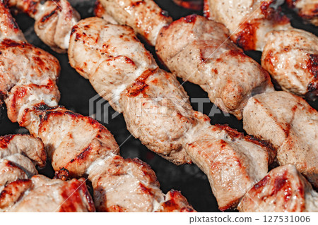 Meat pickled cooked in chunks on barbecue, close-up, selective focus Meat pickled cooked in chunks on barbecue, close-up, selective focus 127531006