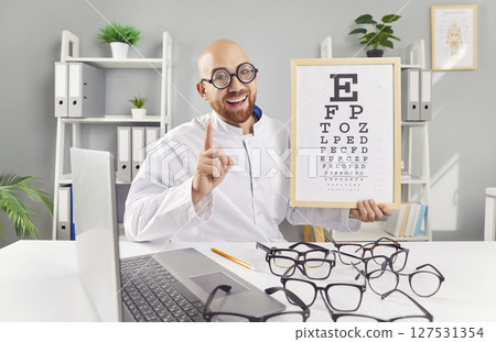 Portrait Of A Funny Ophthalmologist Or Optometrist Holding Vision Chart 127531354