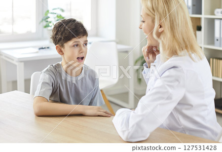 Speech Therapist Conducting Language Development Exercise With Child 127531428